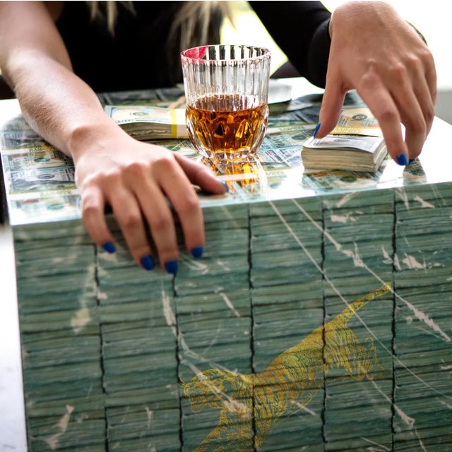 Introducing the one-of-a-kind Money Table - a versatile piece of furniture that adds a touch of quirkiness to any room in...