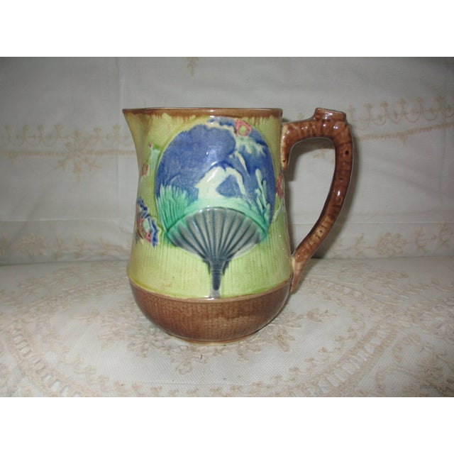 This is a Beautiful Antique 1800s Majolica Chinese Fan Design Pitcher with a blue Fan and Green on a yellow background...