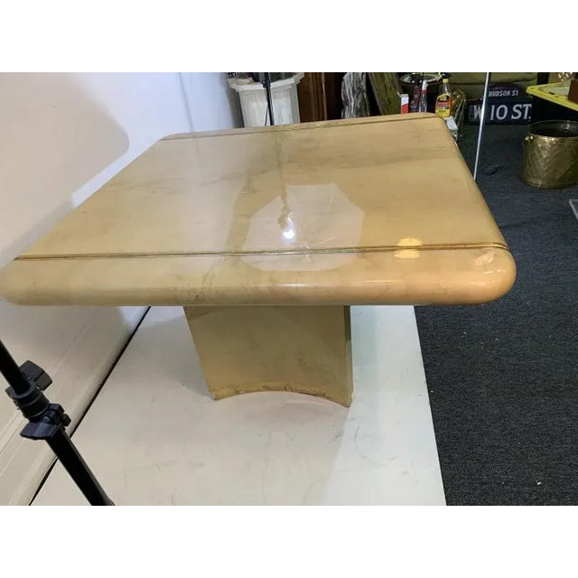 High End Tan And Cream Variance Lacquered Goatskin Dining Table with Gold Leaf Edging. Designed with a Flared Double...