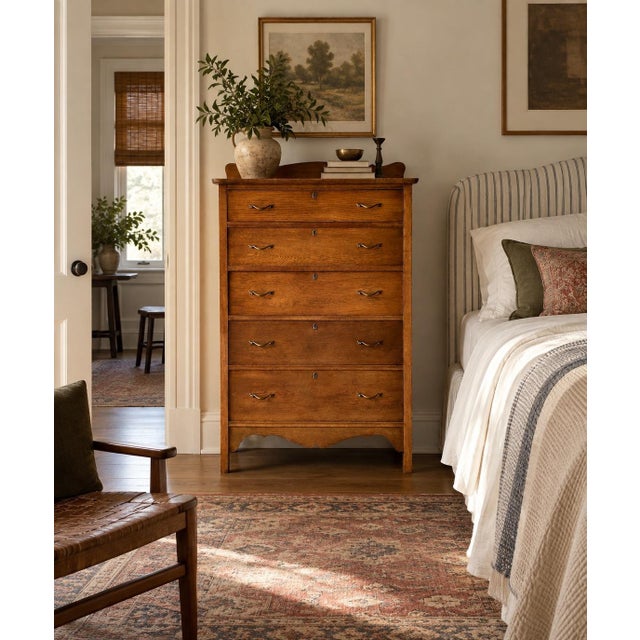 This antique dresser features scalloped detailing at both the shaped backsplash and apron, with five graduated dovetailed...