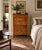 This antique dresser features scalloped detailing at both the shaped backsplash and apron, with five graduated dovetailed...
