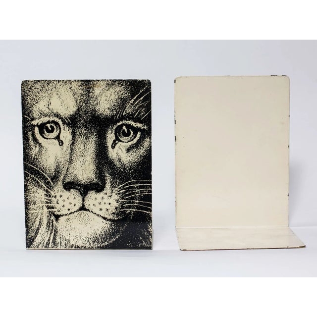 Fornasetti Bookends signed in gold letters on red felt base. size 8" tall 5 3/4" wide foot 5 1/4" deep. Very collectable.