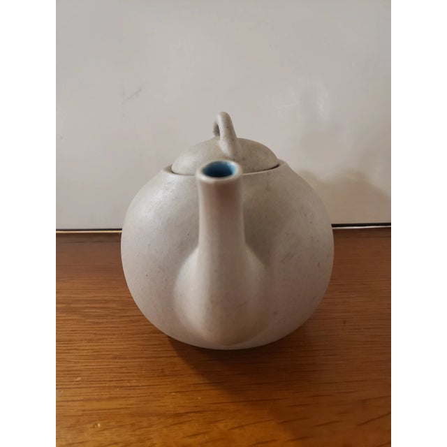 This is a The Pigeon Forge Pottery Dogwood Motif Small Teapot Stoneware Decor, Tennessee. It measures 4 3/4" high, 7" wide...