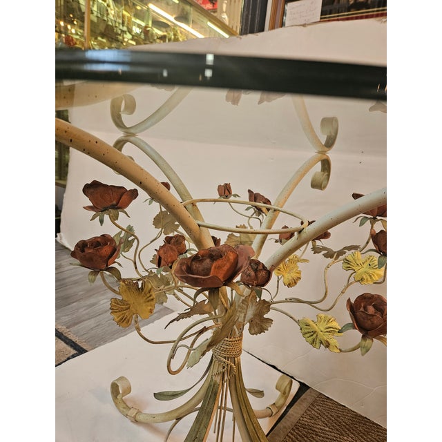 Charming Italian painted Tole table having polished and beveled half inch glass top. Scrolled feet and pink roses, green...