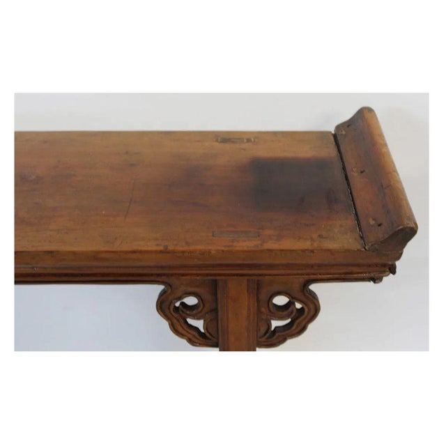 A Chinese hardwood altar table, showcasing the elegance and architectural style associated with traditional Ming dynasty...
