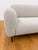 Mid century inspired sofa in a cool toned beige boucle. Black metal legs add to its clean contemporary look.