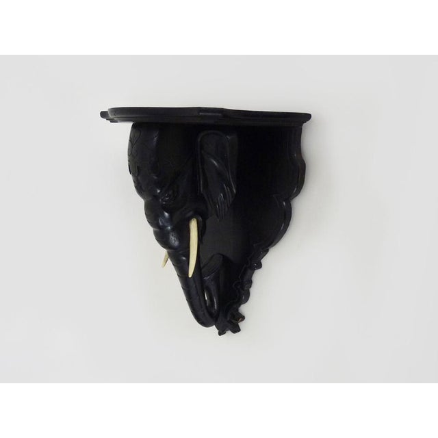 Salle, Plant door, wall statue door, lamp of blackened wooden elephant head. Late 19th century Sallete or wall console at...