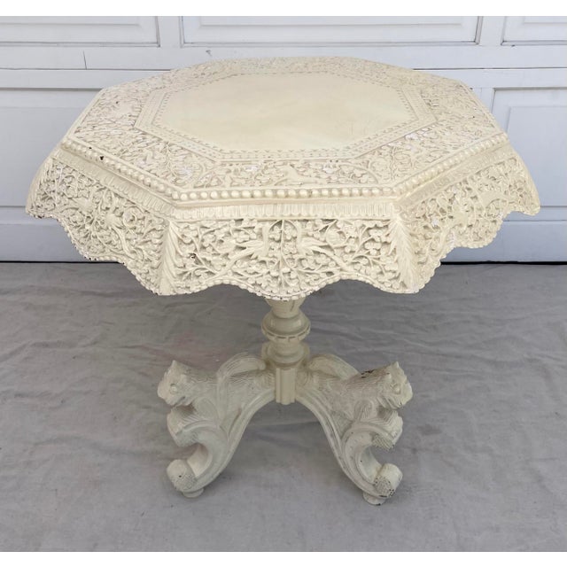 Here is a stunning carved wood side table with an octagonal shaped top and pedestal base. The table dates from the mid-...