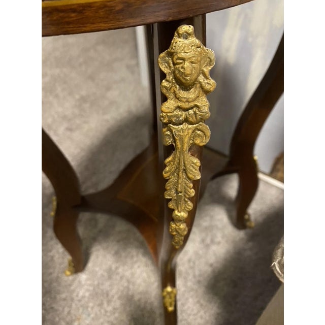 A refined and elegant pair of antique French oval salon tables, crafted in the Louis XV taste and adorned with beautifully...