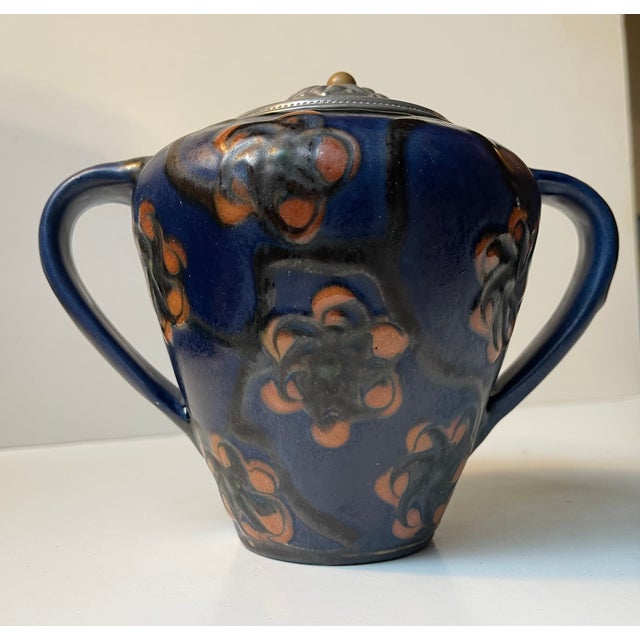 Glazed earthenware vase decorated with flowers upon a blue background. Distinct danish art nouveau, arts and crafts,...