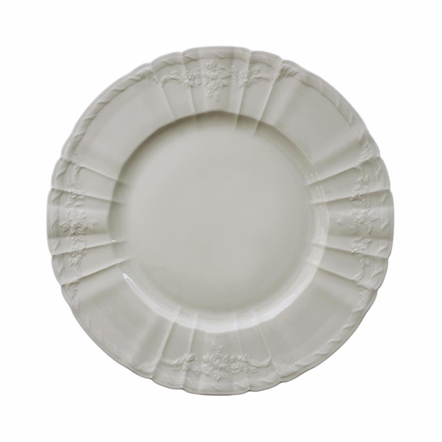 Elegant vintage KPM porcelain 10-piece dinner plate set in a soft cream color. Each plate is shaped with scalloped borders...