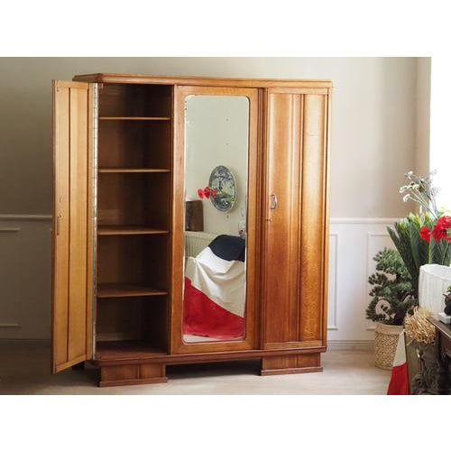 Art Deco wardrobe from France, stamped 1934. The clearly defined verticals, the simplified structure, and the central...