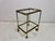 A stylish French brass drinks trolley dating from the 1960s, featuring two removable glass trays framed by finely pierced...