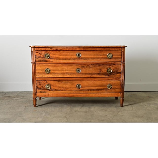 A solid walnut commode from France, 19th century, with all the signature elements of the Louis XVI style exhibiting...