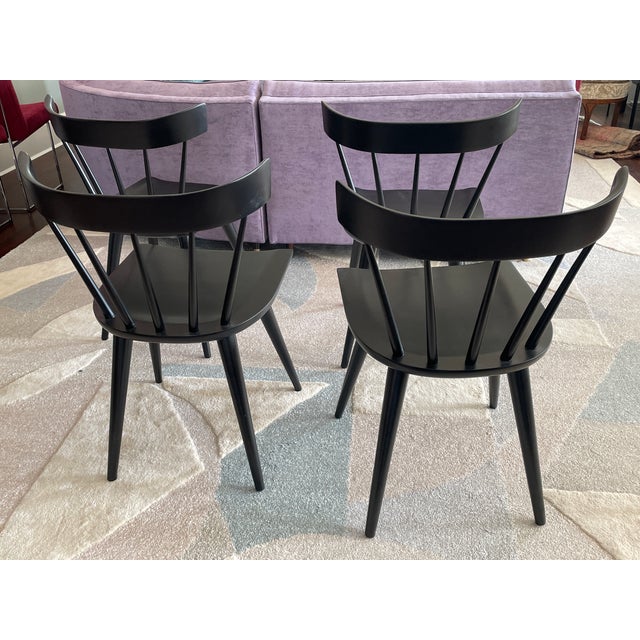 Paul McCobb's classic spindle back dining chairs, recently restored with black satin lacquer. Set of 4.