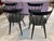 Paul McCobb's classic spindle back dining chairs, recently restored with black satin lacquer. Set of 4.