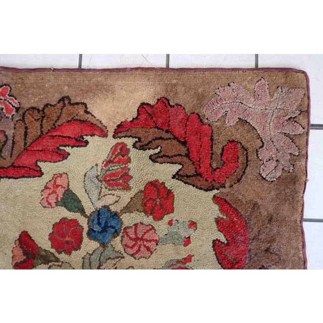 Handmade antique American Hooked rug in floral design. The rug is from the end of 19th century in good condition, the rug...