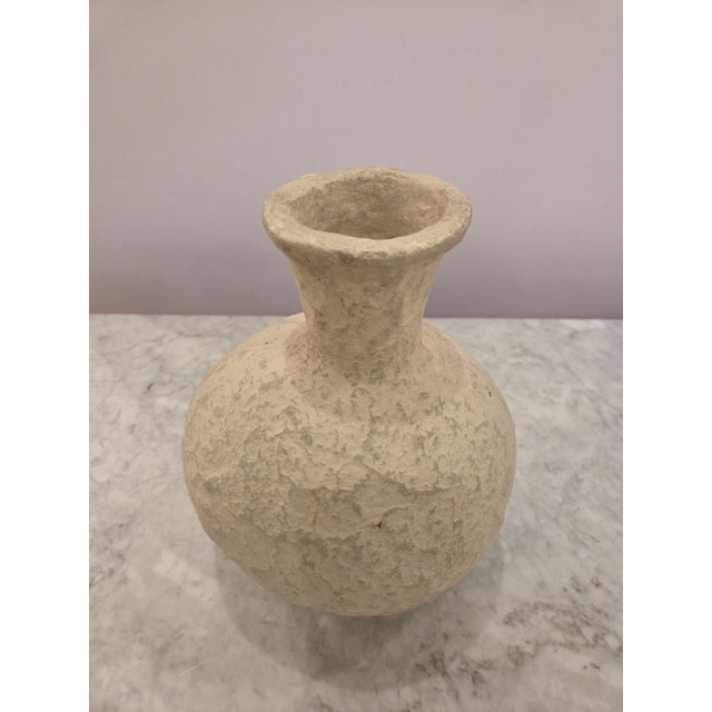 Circular base ceramic vase with narrow opening