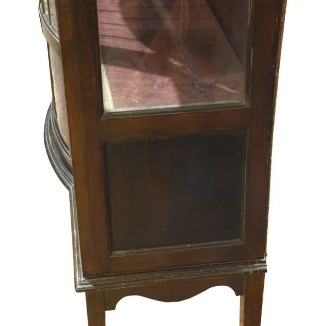 This elegant mahogany display cabinet features inlaid parts and decorations of painted garlands. It features an...