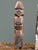This pair of hand carved wooden figures represents folk art traditions from Southeast Asia. The whitewashed example,...