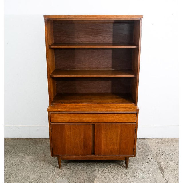 Mid Century Modern walnut display hutch / China cabinet in a unique design. This piece offers many unique features include...