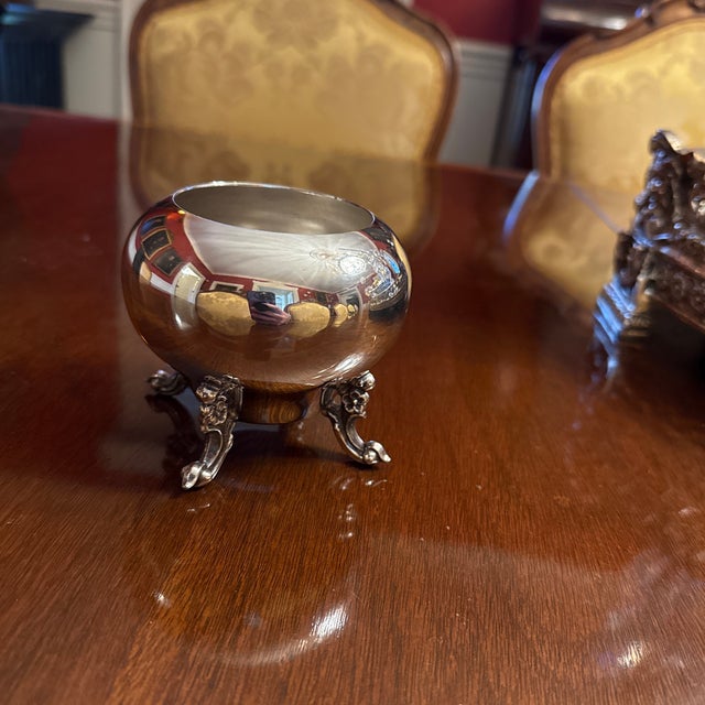 A lovely vintage British silver on copper baster shape bowl with no rim, on rococo, scrolled feet with floral decoration....