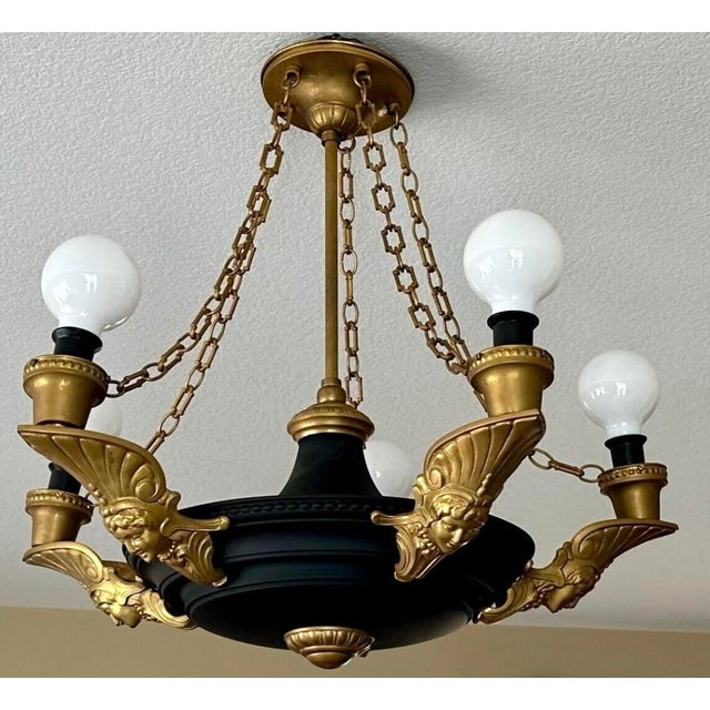 Art Deco Brass Chandelier with Black Flat Paint, Roman Woman Motifs, and Geometric Chain Links This exquisite Art Deco...