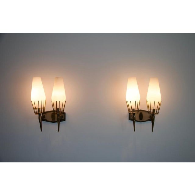 This exquisite pair of wall lamps from 1960s italy embodies the elegance and craftsmanship of mid-century modern design....