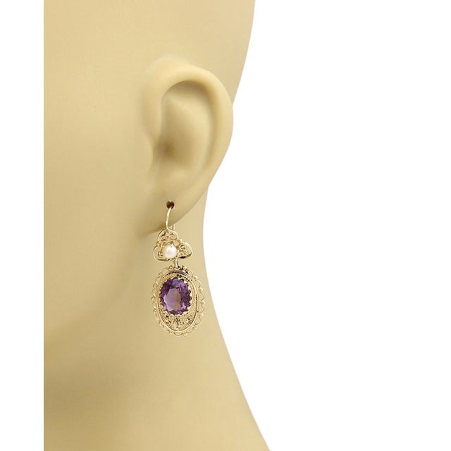 Elevate your accessory collection with these Amethyst Pearls earrings, exquisitely crafted in 14k Yellow Gold. These...