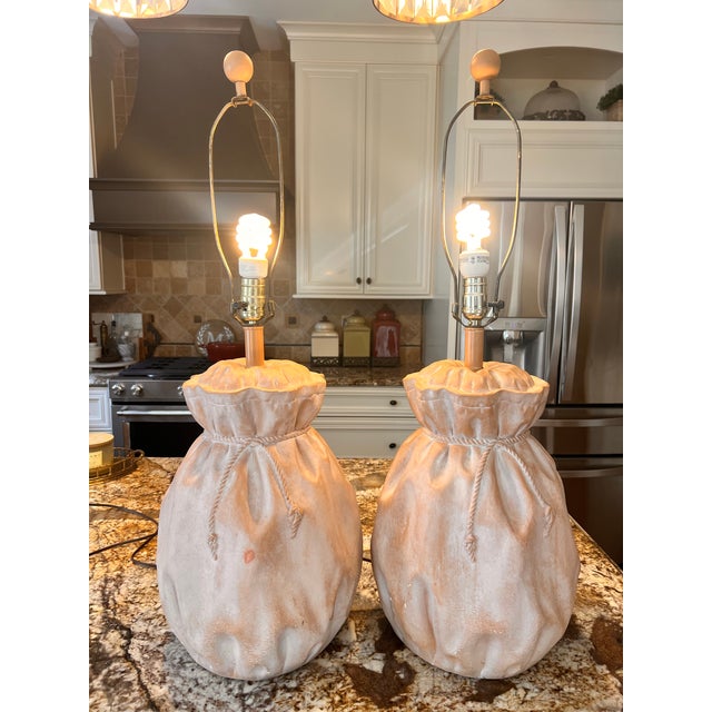 Vintage pair of lamps in good working condition. Color is a salmon pink. 16 inch to top a bag, 21 inch to top of socket,...