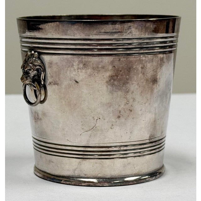 Petite vintage silverplate vessel featuring engraved details to body and diminutive lion head handles. Likely originally a...