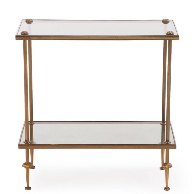 Elegant and sleek two-tier end table, perfect for displaying your books or collections. This vintage Neoclassical accent...