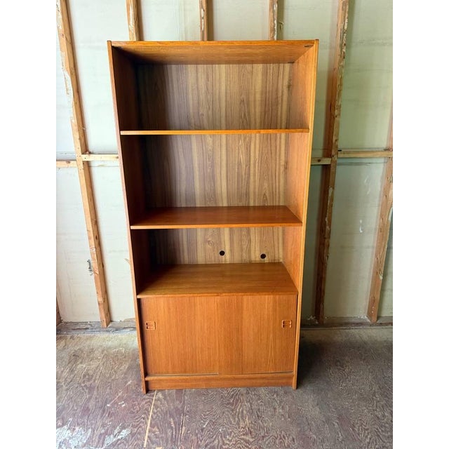 Pair of Danish Modern Teak Bookcase w Storage Cabinets It features pressed wood construction, teak veneer, two adjustable...