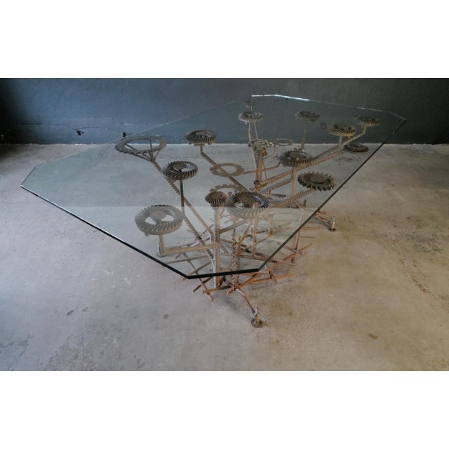 This stunning industrial dining table features a spacious glass top that provides an elegant and modern surface for...