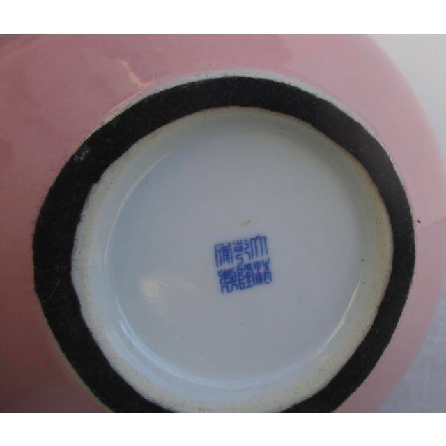 Chinese Porcelain bottle neck vase. Monochrome with a dull pink glaze over the entire surface and a white interior. The...