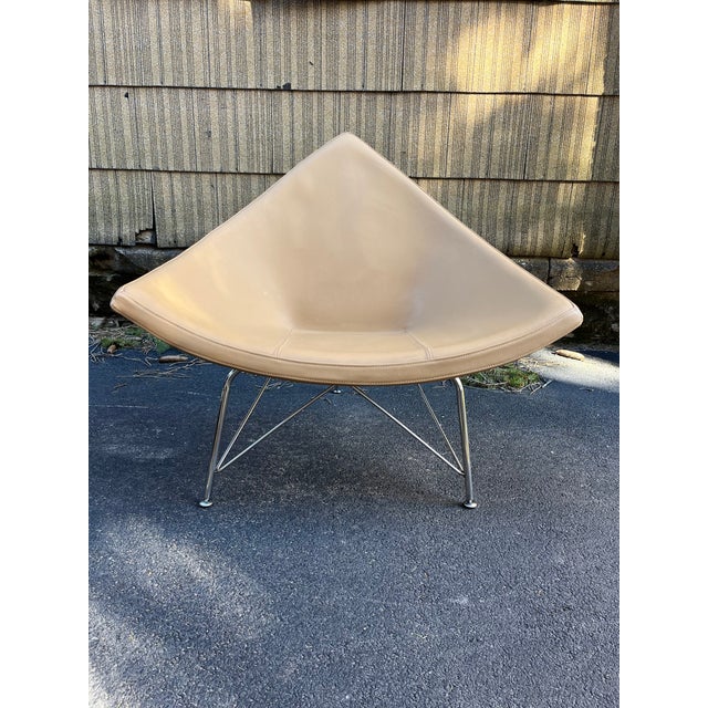 A single George Nelson Coconut style lounge chair with chrome legs, fiberglass body, and tan vinyl upholstered seat.