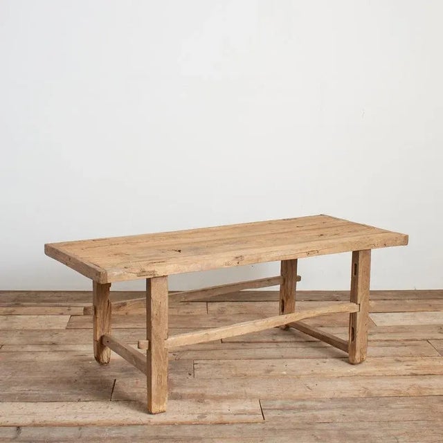 A beautiful vintage solid wooden elm coffee table with some lovely original patina. The weathered plank table top has...