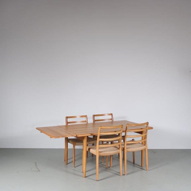 A beautiful set of an extendible dining table with four matching chairs, designed and manufactured by moller in denmark...