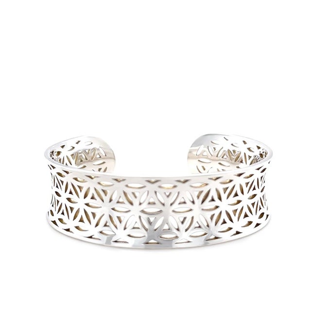 A striking sterling silver cuff style bangle featuring an intricate cut-out pattern throughout the design. Bold yet...