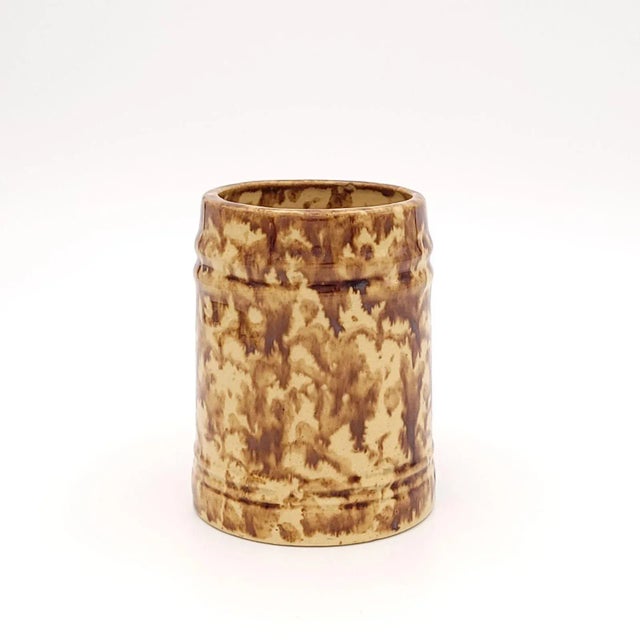 An early stoneware treacle glazed mug, England, 18th century or earlier.