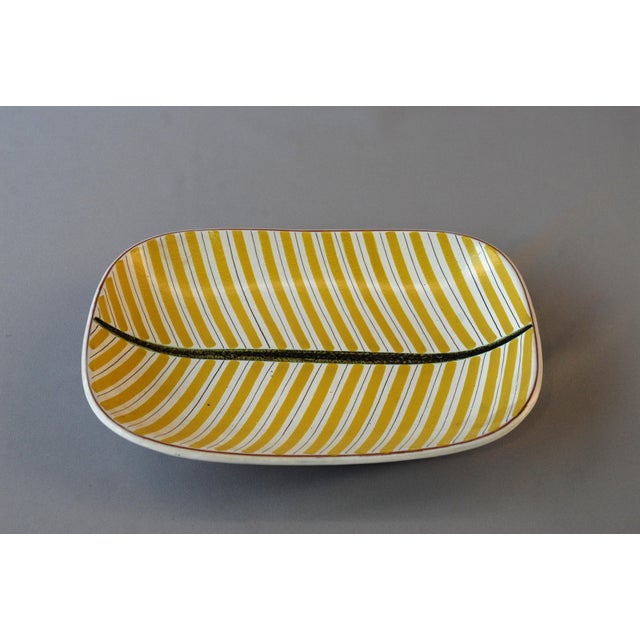 Stig Lindberg's large studio Faience Series bowl, milky white glaze, and a polychrome stripe decoration. It was decorated...