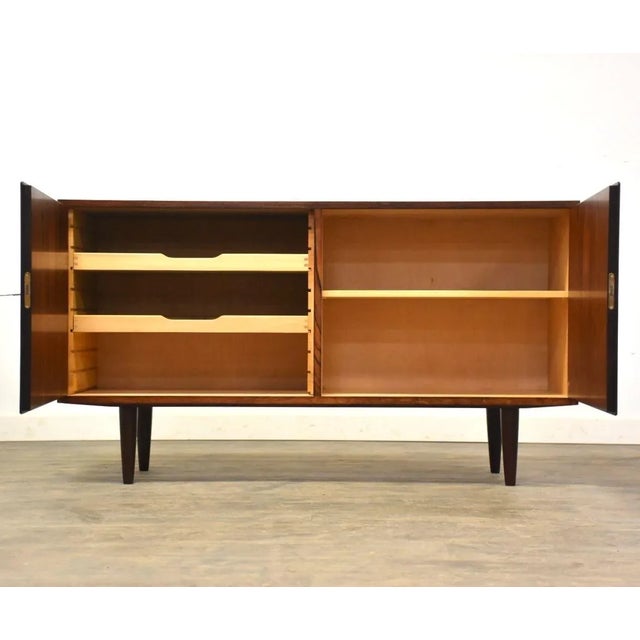 A mid century modern rosewood sideboard credenza designed by Carlo Jensen for Hundevad Co. Beautiful polished brass...