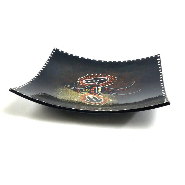 Unique black lacquer bowl or tray made by the aboriginal people of Australia. A kangaroo can be found among the dots and...