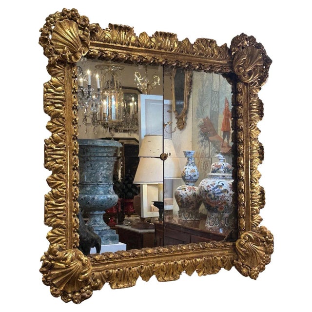 A Northern Italian, hand-carved, gessoed and gilded 18th century frame with laurel leaves and shell details. 4 paneled...