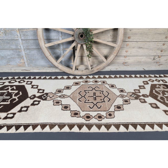 Vintage Turkish Hand-Knotted vintage rug is a semi-Vintage runner rug.'70s Eastern region of Turkey's unique rug is...