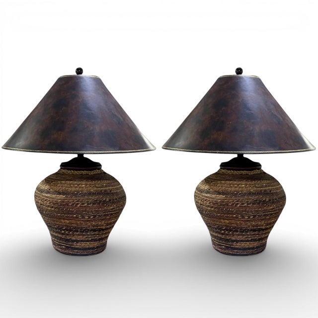A pair of large Maitland Smith table lamps, having a substantial base wrapped in natural seagrass with braided roped at...