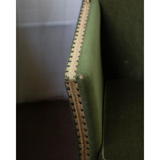 A compact Scandinavian sofa in the Art Deco manner, produced in the 1940s and upholstered in mohair with fringe trim. The...