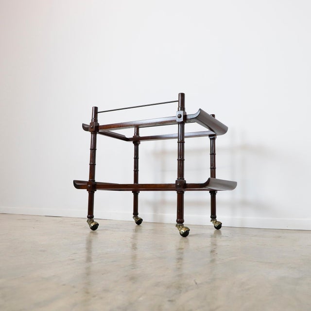 Rare rolling bar or serving cart made of mahogany and brass, designed by Frank Kyle, circa 1950. We offer this item...