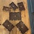 Add a touch of antique Indian craftsmanship to your space with this set of six rosewood trays, each featuring finely...