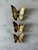Set of 3 vintage brass butterfly wall hangings featuring a classic mid century design with detailed embossed wings. Set...